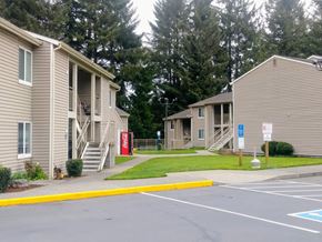 Reedsport apartment for rent - an empty parking lot in front of a row of houses