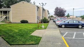 Reedsport apartment for rent - a row of cars parked in a parking lot