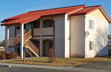 Ontario apartment for rent - a white building with a red roof on a street