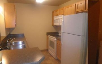 Shelby apartment for rent - a kitchen with a white refrigerator and a sink