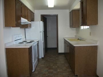 Caldwell apartment for rent - an empty kitchen with a stove refrigerator and sink