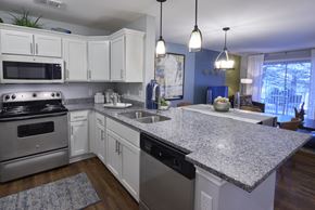 Auburn Hills apartment for rent - A kitchen with white cabinets and a granite countertop.