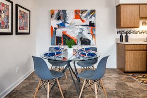 Belleville apartment for rent - A dining room with a table set for two and a large abstract painting on the wall.