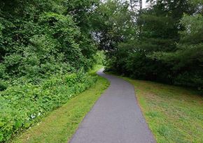 Plainsboro Township apartment for rent - a paved path in a park with trees and grass