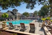 Newark apartment for rent - Poolside seating at Sycamore Bay apartments in Newark.
