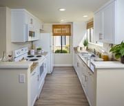 Irvine apartment for rent - Model kitchen area with white cabinets at Woodbridge apartments in Irvine.