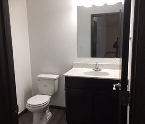 Belle Plaine townhouse for rent - a bathroom with a toilet and a sink and a mirror