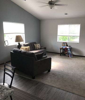 Belle Plaine townhouse for rent - a living room with a couch and a chair and a ceiling fan