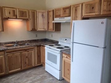 Billings apartment for rent - a kitchen with white appliances and wooden cabinets
