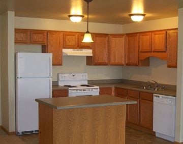 Billings apartment for rent - a kitchen with white appliances and wooden cabinets