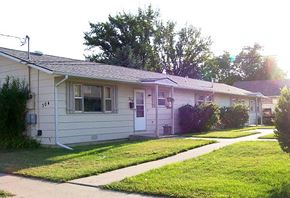Billings triplex for rent - a white house with a sidewalk in front of it
