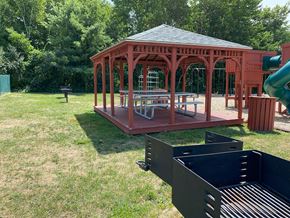 Milford apartment for rent - A gazebo is surrounded by a green lawn.