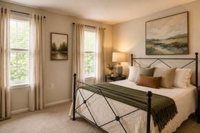 Baltimore townhouse for rent - A bedroom with a large bed and a painting on the wall.