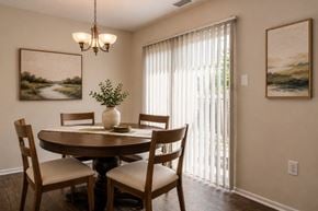 Baltimore townhouse for rent - A dining room with a table set for two and a plant on the table.
