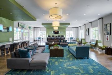 Baltimore townhouse for rent - a large living room with couches and chairs and a bar