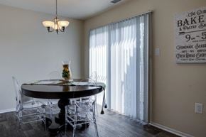Baltimore townhouse for rent - a dining room with a table and chairs and a window