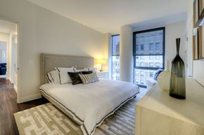 Chicago apartment for rent - a bedroom with a large bed and a large window