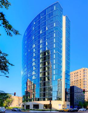 Chicago apartment for rent - a tall blue building with a street in front of it