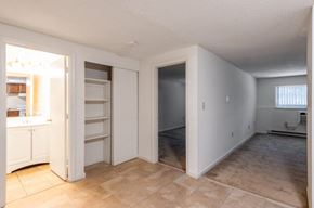 Lowell apartment for rent - an empty living room with a kitchen and a closet