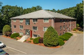Lowell apartment for rent - an aerial view of a brick apartment building with a parking lot