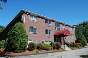 Lowell apartment for rent - a brick apartment building with a red awning