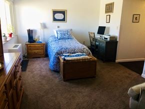 Salt Lake City apartment for rent - a bedroom with a bed and a dresser and a window