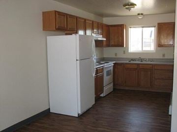 Missoula apartment for rent - a kitchen with a white refrigerator and a sink