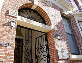 Philadelphia apartment for rent - the front door of a brick building with a wrought iron gate