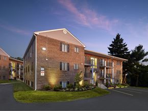 Phoenixville apartment for rent - an exterior view of a brick apartment building at dusk