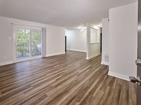 Phoenixville apartment for rent - the living room and dining room of an empty house with wood flooring