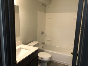 Everett apartment for rent - A white toilet sits next to a white sink in a bathroom.