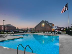 Owasso apartment for rent - the preserve at ballantyne commons pool and flag at night