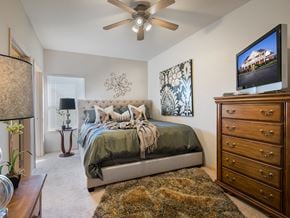 Stillwater apartment for rent - a bedroom with a bed and a ceiling fan