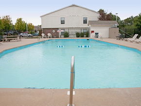 Rogers apartment for rent - a swimming pool with a building in the background