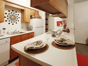 Rogers apartment for rent - a kitchen with a counter with plates on it