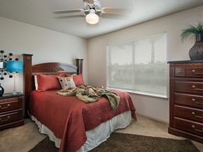 Lowell apartment for rent - a bedroom with a bed and a ceiling fan