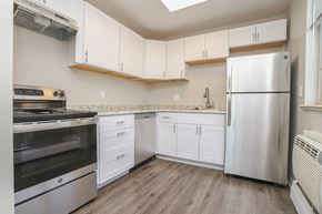 Denver apartment for rent - A kitchen with white cabinets and a stainless steel refrigerator.