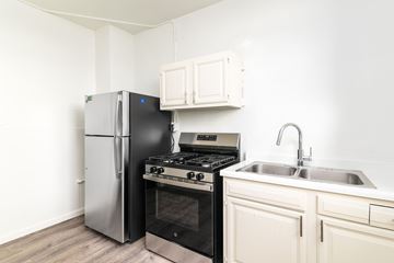 San Francisco apartment for rent - A kitchen with a stainless steel refrigerator, oven, and sink.