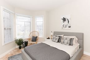 San Francisco apartment for rent - a bedroom with a bed and a chair and a painting of a dog