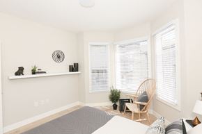 San Francisco apartment for rent - a bedroom with a bed and a chair and three windows