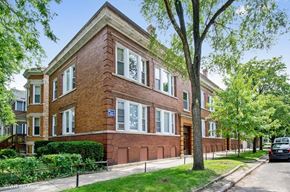 Chicago apartment for rent - a brick building with a tree in front of it