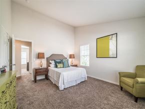 Hilliard townhouse for rent - a bedroom with a bed and a chair