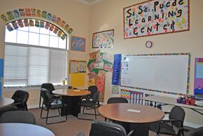 Temple apartment for rent - a classroom with tables and chairs and a whiteboard