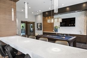Hanover apartment for rent - A pool table is in the middle of a room with a bar and a TV.