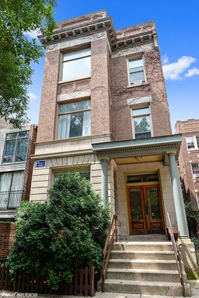Chicago apartment for rent - the front of a brick building with stairs and a wooden door