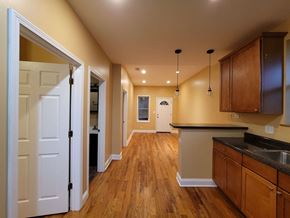 Chicago apartment for rent - a kitchen with wooden floors and a white door