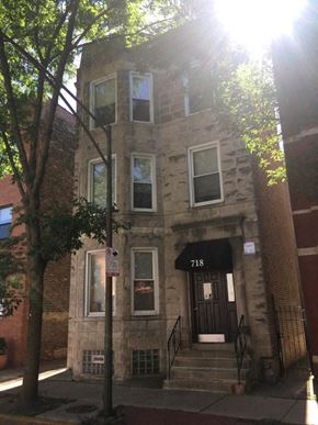 Chicago apartment for rent - the front of a brick building with a black door