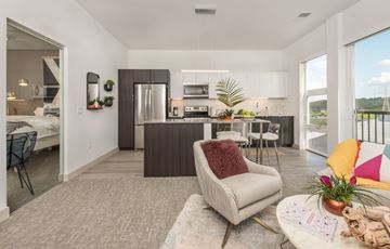 Brookfield apartment for rent - a living room with a couch and a chair in front of a kitchen