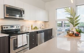 Brookfield apartment for rent - a kitchen with stainless steel appliances and a counter top and a window