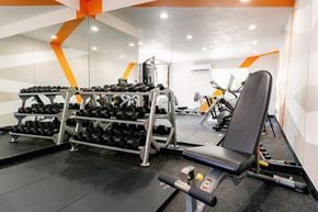 Las Vegas apartment for rent - a gym with weights and a chair in the corner of a room